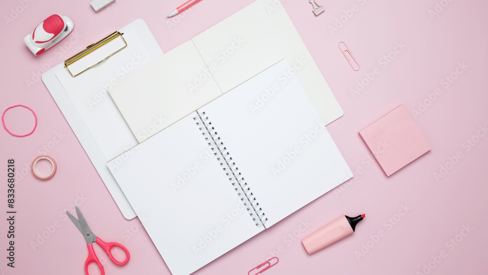 Creative flat lay mockup design of workspace. Top view composition with white notebook, to do list and stationery on pink background Creative flat lay mockup design of workspace. Top view composition with white notebook, to do list and stationery on pink background