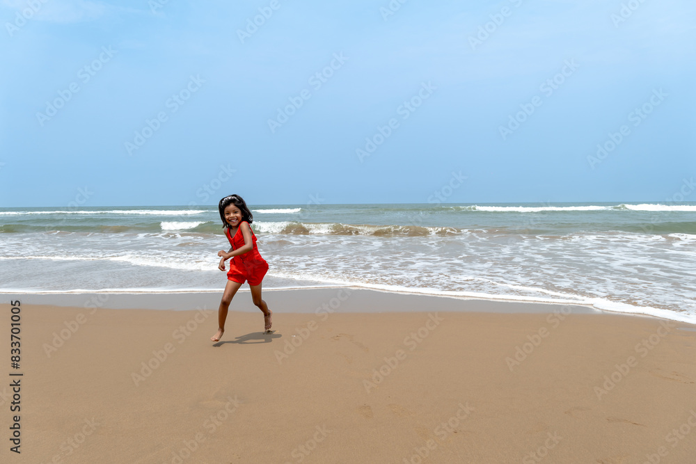 Seaside Reverie Child in Red Dress by the Calm Ocean Seaside Reverie Child in Red Dress by the Calm Ocean