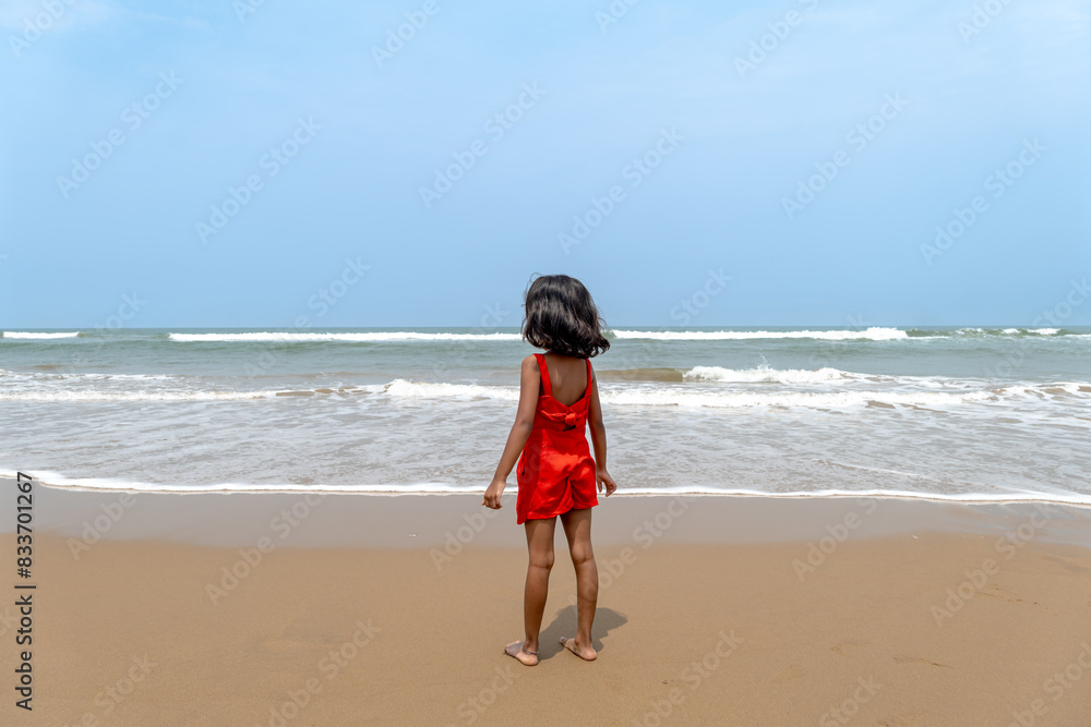 Solitude by the Sea Young Child Contemplates Ocean Waves