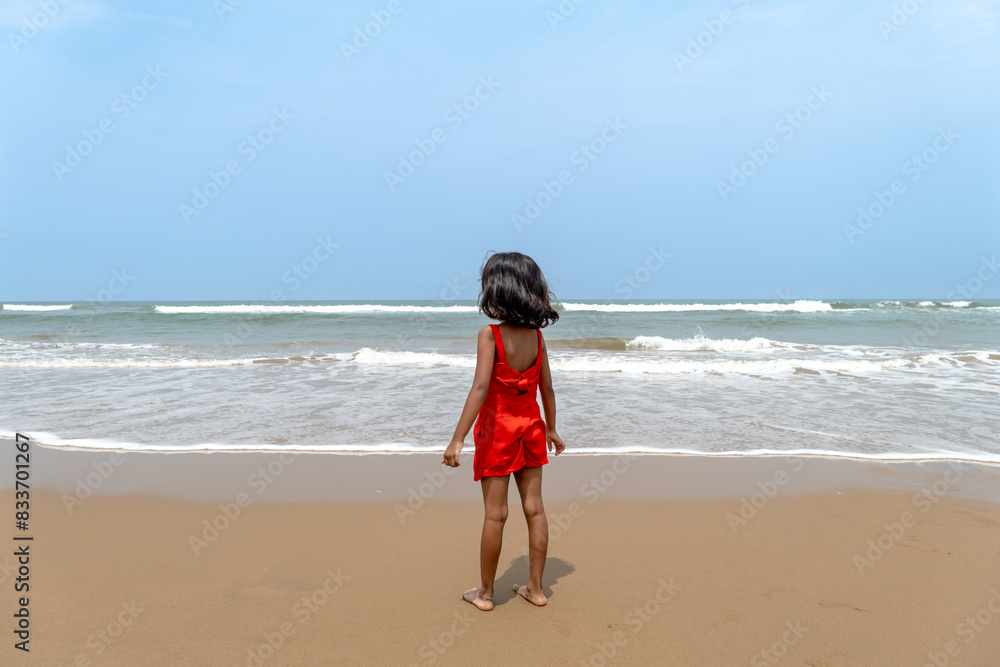 Solitude by the Sea Young Child Contemplates Ocean Waves Solitude by the Sea Young Child Contemplates Ocean Waves