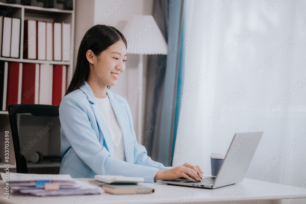 Happy young woman uses laptop computer for virtual meeting Have a video call at home Cheerful Asian woman communicating with colleagues and friends Happy young woman uses laptop computer for virtual meeting Have a video call at home Cheerful Asian woman communicating with colleagues and friends