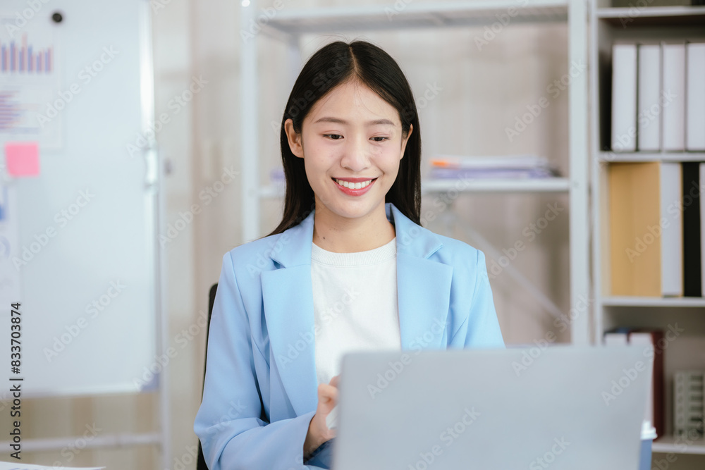 Happy young woman uses laptop computer for virtual meeting Have a video call at home Cheerful Asian woman communicating with colleagues and friends Happy young woman uses laptop computer for virtual meeting Have a video call at home Cheerful Asian woman communicating with colleagues and friends