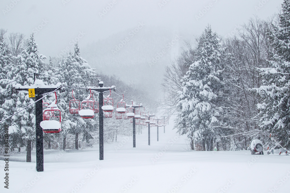 Ski mountain chairlift winter deep snow powder with snowy trees on a mountainside Ski mountain chairlift winter deep snow powder with snowy trees on a mountainside