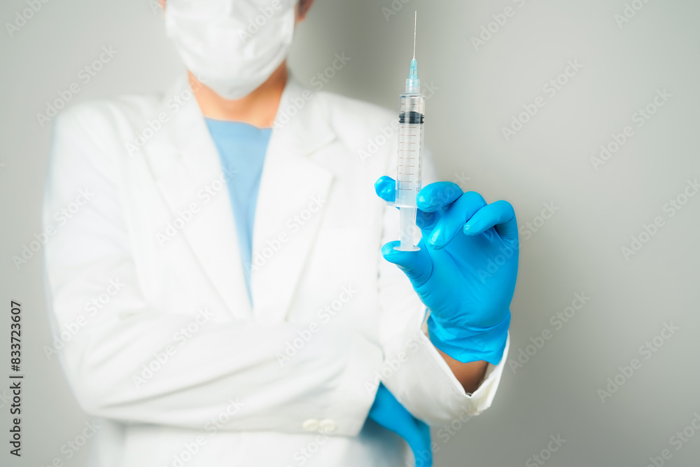 doctor or scientist holding a syringe in blue gloves doctor or scientist holding a syringe in blue gloves