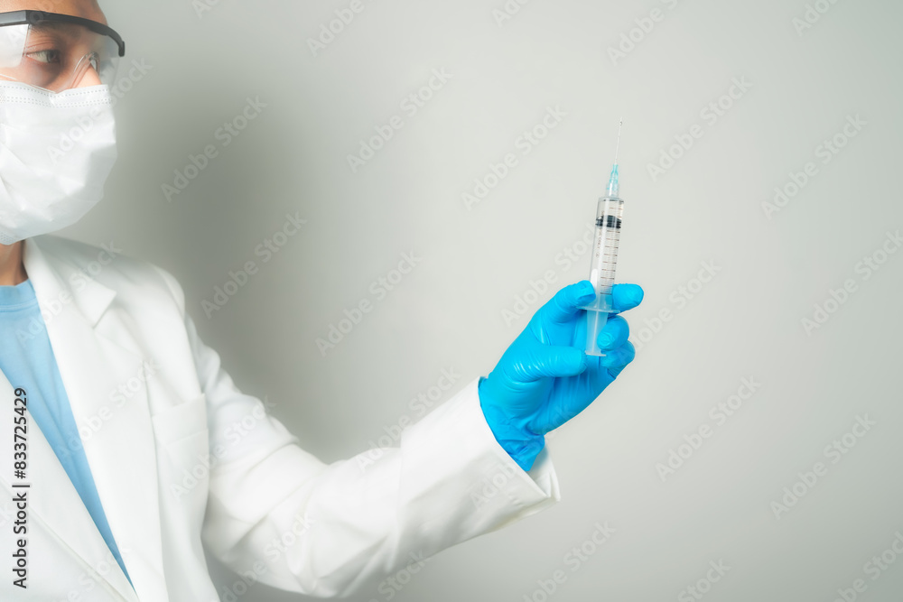doctor or scientist holding a syringe in blue gloves doctor or scientist holding a syringe in blue gloves