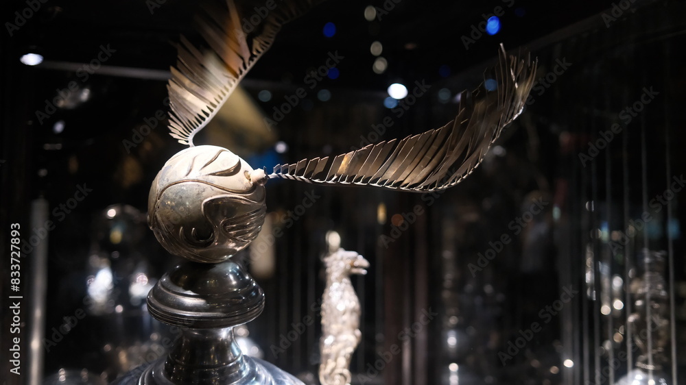Fototapeta premium Tokyo - May 15 2024: a movie props of Golden Snitch in movie. Warner Bros. Studio make a new tour about the movie of Harry Potter 