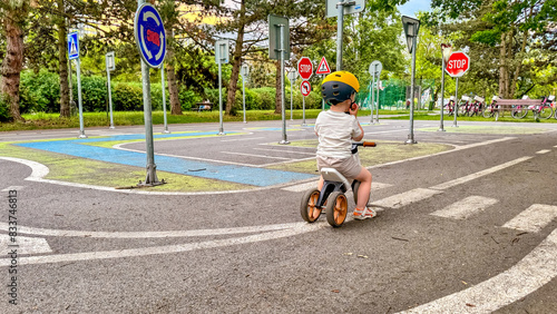 A child learns the rules of the road on his bike - a training park for children