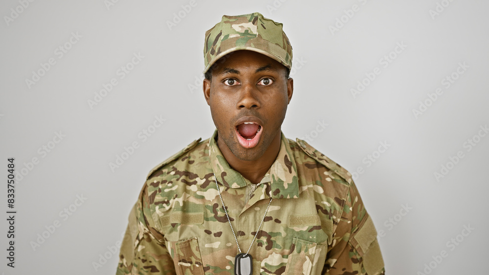A surprised african american man in military uniform isolated on a white background, portraying a range of emotion. A surprised african american man in military uniform isolated on a white background, portraying a range of emotion.