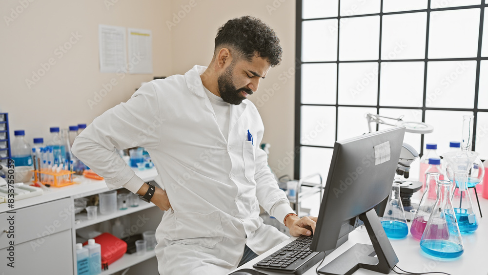 Handsome bearded man in pain at laboratory indoor clinic Handsome bearded man in pain at laboratory indoor clinic
