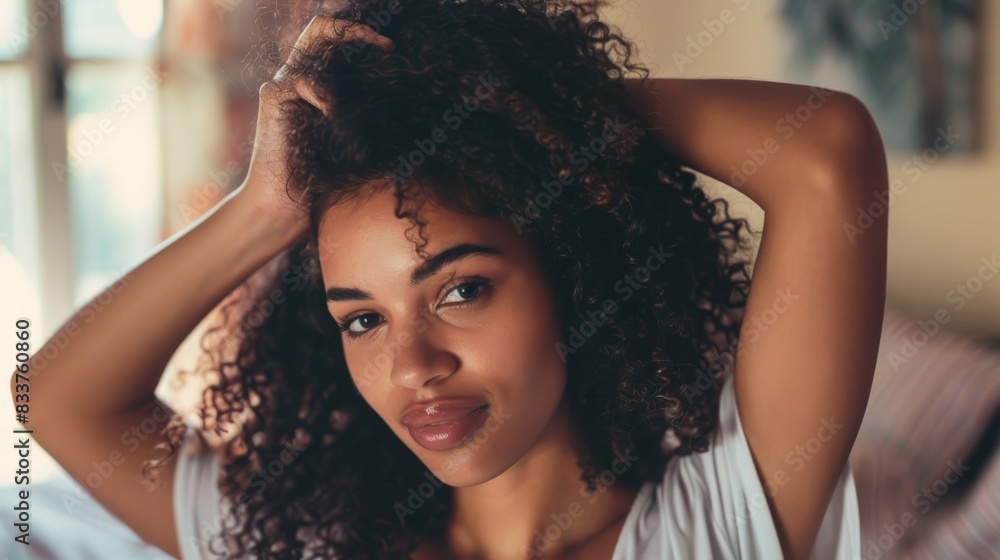 Curly girl method, Healthy routine for beautiful curls. Smiling woman with voluminous curls combing her hair. Curly girl method, Healthy routine for beautiful curls. Smiling woman with voluminous curls combing her hair.