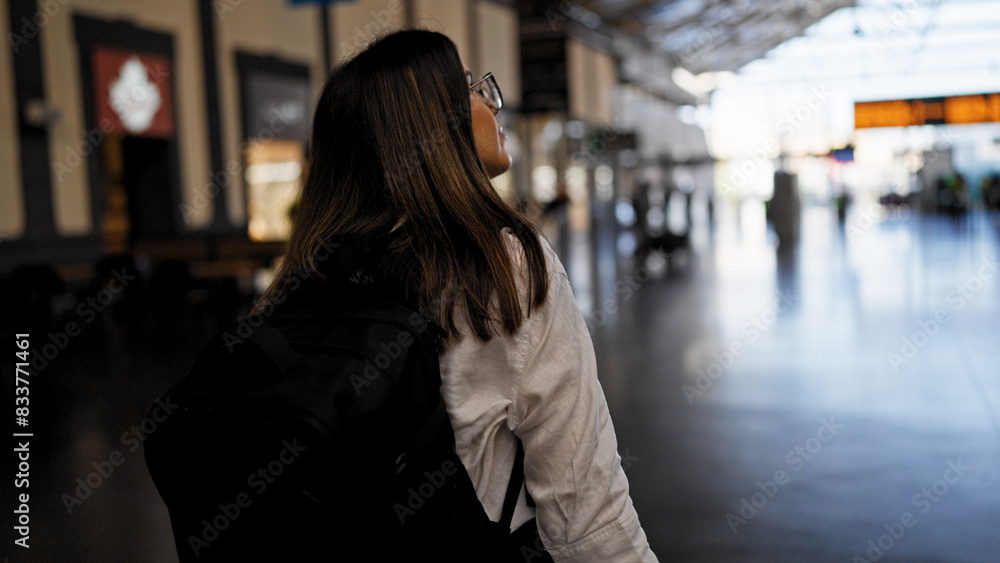 Young beautiful hispanic woman going on a trip at train station Young beautiful hispanic woman going on a trip at train station