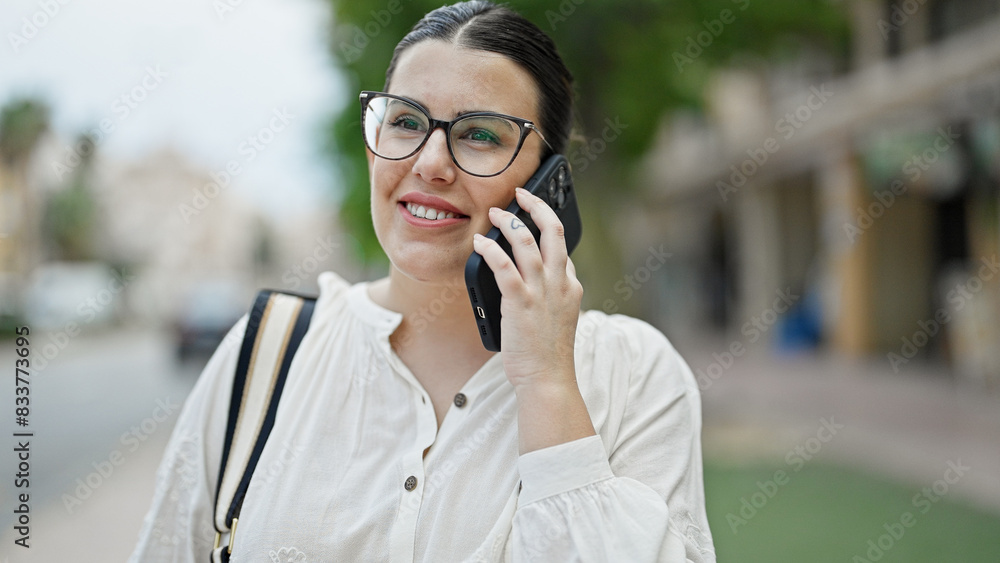 Young beautiful hispanic woman speaking on the phone at street Young beautiful hispanic woman speaking on the phone at street