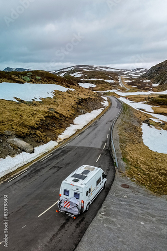 Campervan or motorhome travel camper van, at the Lyse road covered with snow to Krejag Norway Lysebotn, road covered with snow  photo