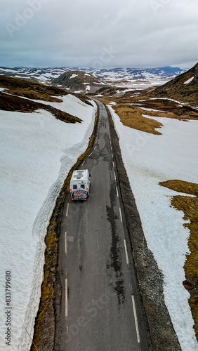 Campervan or motorhome travel camper van, Caravan trailer, or camper RV at the Lyse road covered with snow to Krejag Norway Lysebotn, road covered with snow in Spring in the mountains photo