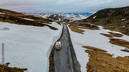 travel camper van, Caravan trailer, or camper RV at the Lyse road covered with snow to Krejag Norway Lysebotn, a road covered with snow in Spring photo