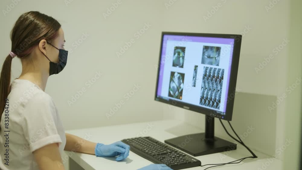 Dental Technician Reviewing X-Ray Images on Computer Dental Technician Reviewing X-Ray Images on Computer