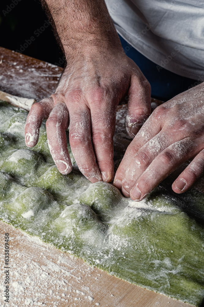 Close-up of male hands skilfully preparing handmade ravioli. Close-up of male hands skilfully preparing handmade ravioli.