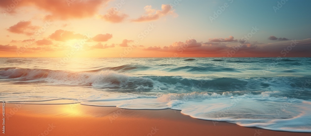 A breathtaking image of a serene beach at sunset with ocean waves, offering a peaceful paradise vibe and plenty of copy space image.