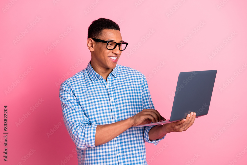 Photo of handsome confident guy wear plaid shirt typing modern gadget emtpy space isolated pink color background Photo of handsome confident guy wear plaid shirt typing modern gadget emtpy space isolated pink color background