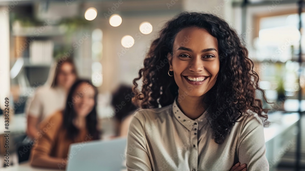 Female leader in a modern office, smiling while working on a project with colleagues. Female leader in a modern office, smiling while working on a project with colleagues.