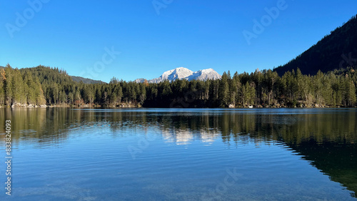 Lake Hintersee in Bavaria, Germany, with forested shoreline and the Alps in the background, showcasing serene and picturesque natural beauty