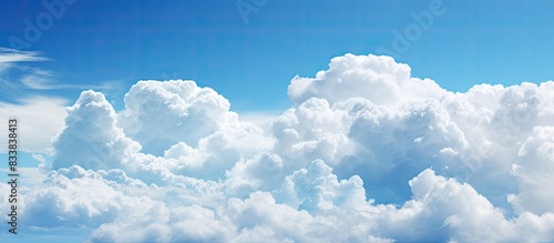 Background of a blue sky with puffy clouds and copy space image.