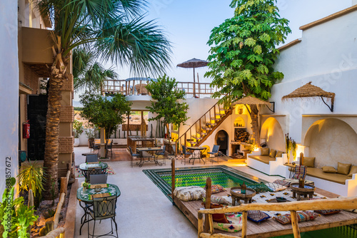 Illuminated with lights courtyard with swimming pool of traditional riad guesthouse in the evening in Taroudant town in Atlas Mountains, Morocco, North Africa