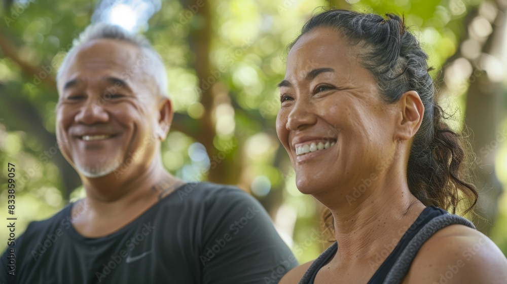 A man and woman smiling together in a park enjoying each other's company. A man and woman smiling together in a park enjoying each other's company.