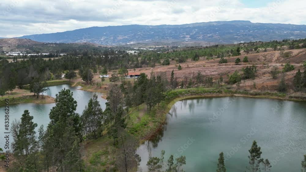 Aerial view of the Blue Wells surrounded by trees and arid desert land in Villa De Leyva, Colombia Aerial view of the Blue Wells surrounded by trees and arid desert land in Villa De Leyva, Colombia