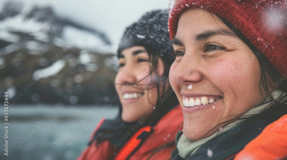 Two smiling women in winter gear enjoying the snowy mountain landscape. Two smiling women in winter gear enjoying the snowy mountain landscape.