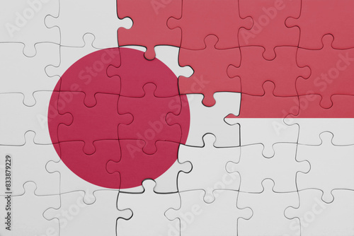 puzzle with the colourful national flag of indonesia and flag of japan.