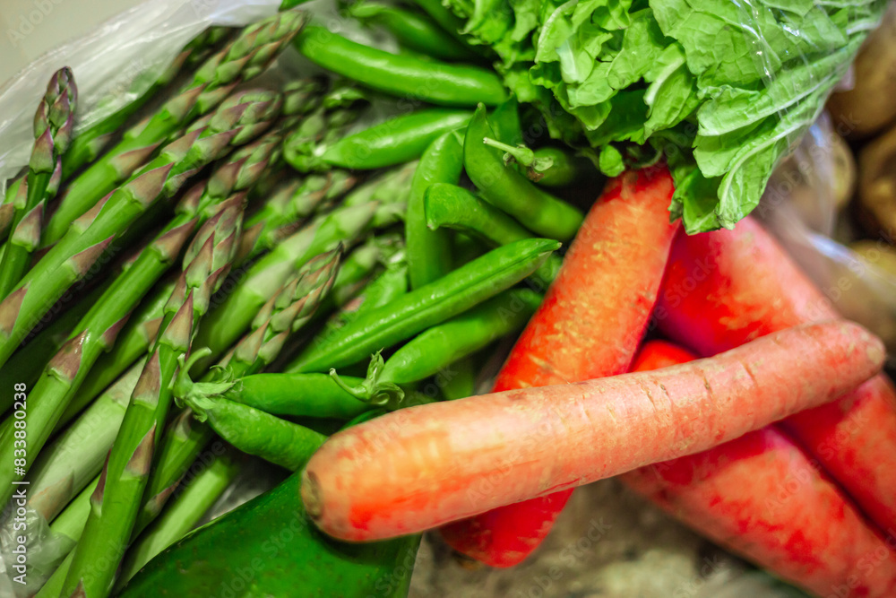 Asparagus officinalis bundle. Ripe green peas. Whole avocado. Orange carrots. Organic raw grocery vegetables. Asparagus officinalis bundle. Ripe green peas. Whole avocado. Orange carrots. Organic raw grocery vegetables.
