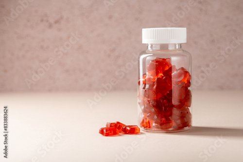 Fruit jelly gummy vitamins in a jar, food supplement.