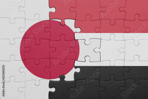 puzzle with the colourful national flag of yemen and flag of japan.