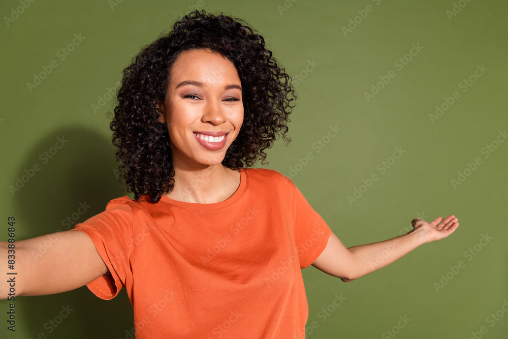 Photo portrait of pretty young girl selfie photo hand point empty space wear trendy orange outfit isolated on khaki color background Photo portrait of pretty young girl selfie photo hand point empty space wear trendy orange outfit isolated on khaki color background