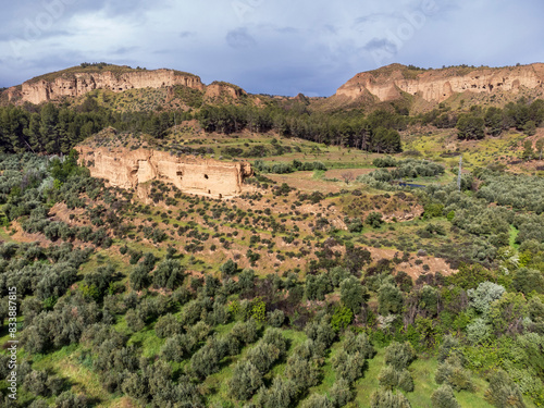 troglodyte granaries in the rock walls of Lares, Granada Geopark, Granada province, Andalusia, Spain