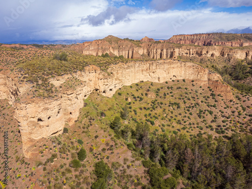 troglodyte granaries in the rock walls of Lares, Granada Geopark, Granada province, Andalusia, Spain photo