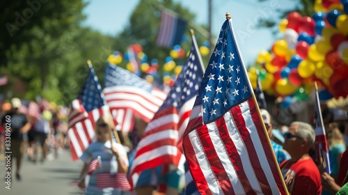 People waving American flags in a parade celebrating the Fourth of July.