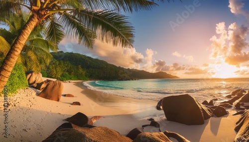 panoramic view of beautiful beach at sunset with coconut palm tree sea and beautiful rocks beau vallon beach mahe island seychelles photo