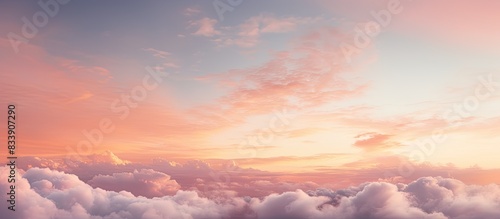 Morning sky at sunrise displaying soft pink clouds with yellow hues, offering a serene backdrop for copy space image.