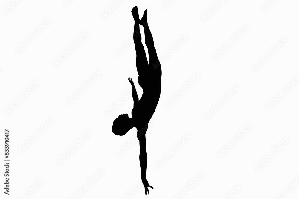 A person in a handstand position against a plain background A person in a handstand position against a plain background