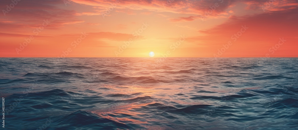 Fototapeta premium Sun setting over the ocean with copy space image.