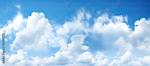 Blue sky with white clouds against a white background, ideal for copy space image.