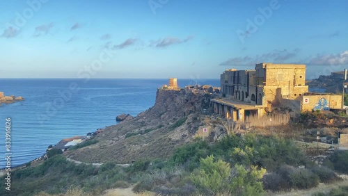 Malta Ghajn Tuffieha bay, World war 2 pillbox, watchtower and abandoned building. Revealing golden sand beach. High quality 4k footage photo
