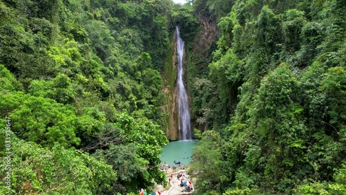 4K Aerial Drone video of beautiful Mantayupan Falls surrounded by jungle with a suspension bridge on a sunny day, Cebu, Philippines photo