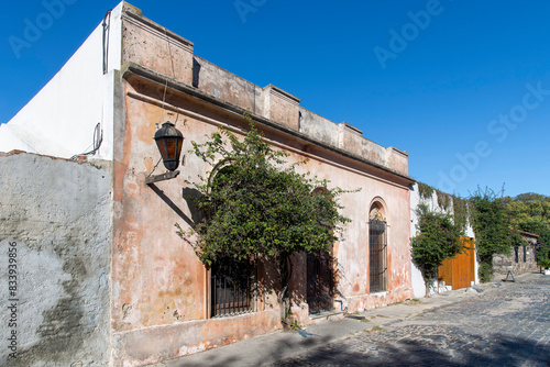 View down one of the cobblestone streets lined with historic buildings in historic quarter of Colonia del Sacramento in Uruguay a UNESCO World Heritage Site along the Río de la Plata photo