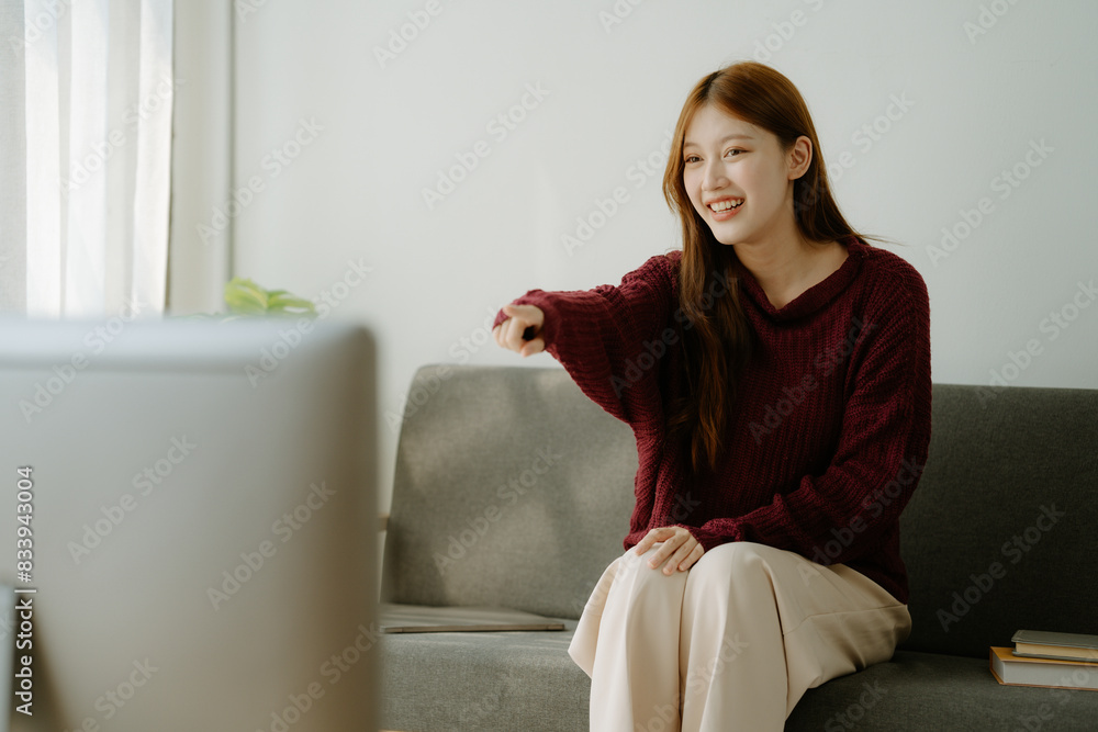 Attractive young Asian woman happily relaxing doing housework Attractive young Asian woman happily relaxing doing housework