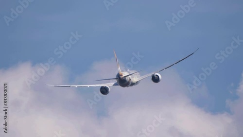 The Commercial passenger airplane flying overhead on sunny day on June  in Moscow, Russia.