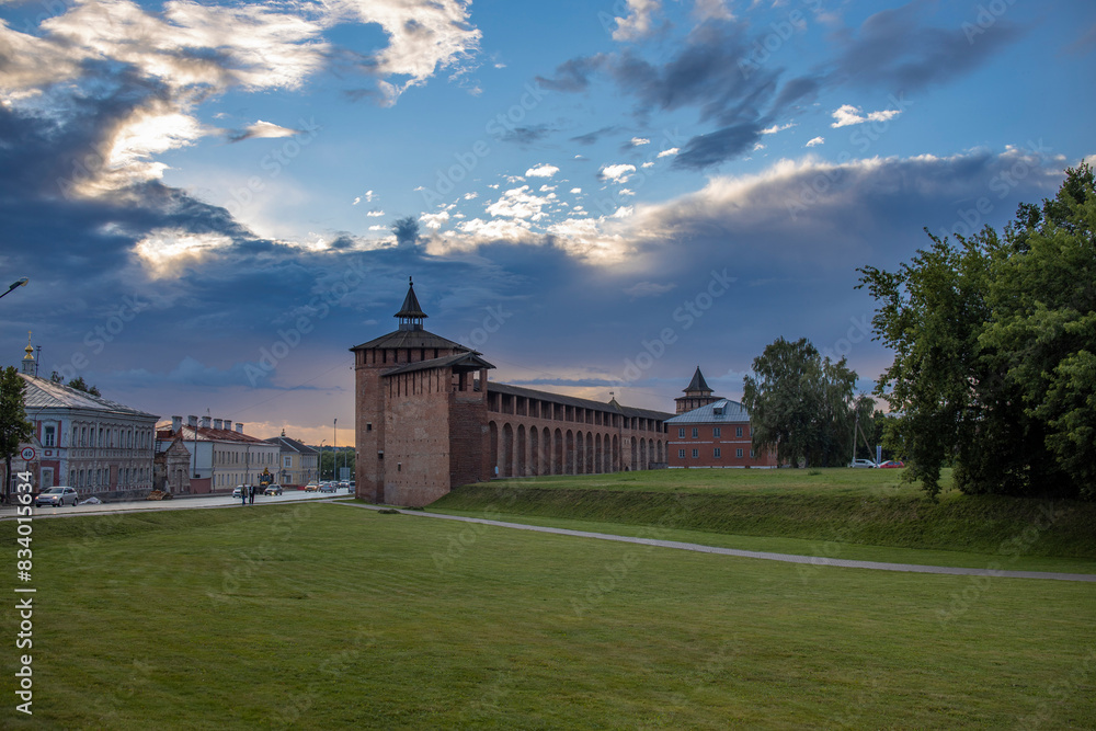 A massive structure looms atop a vibrant, verdant meadow, creating a striking contrast between man-made architecture and natural beauty. A massive structure looms atop a vibrant, verdant meadow, creating a striking contrast between man-made architecture and natural beauty.