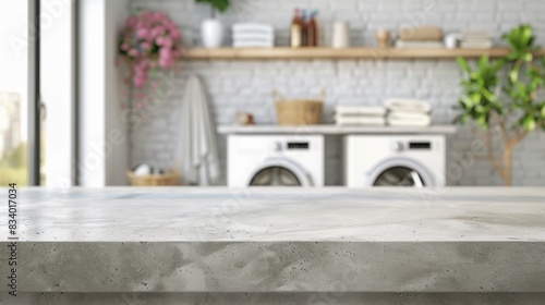 Tabletop in the background of a laundry room with washing machines for product presentation. Empty countertop made of concrete in the interior of the room.